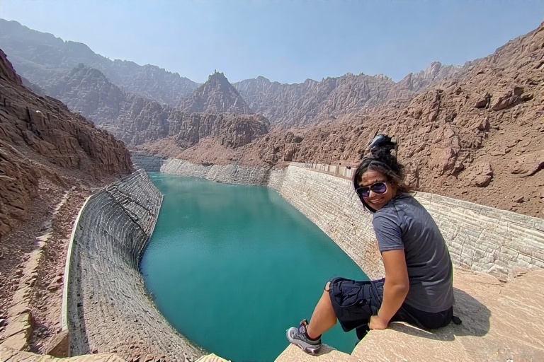 Tourist admiring Hatta Dam’s turquoise waters and mountains